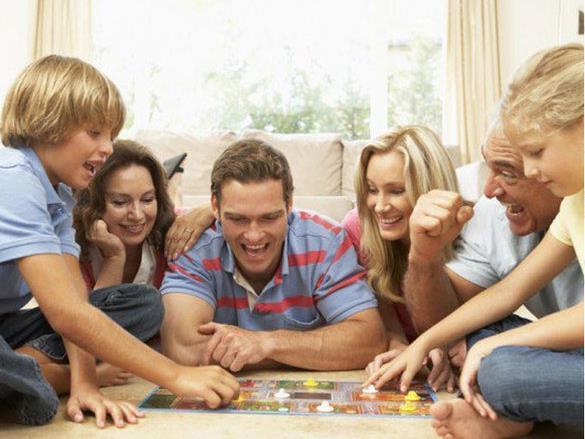 A family playing a Logic Roots math board game together