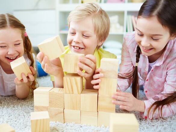 Two children playing a Logic Roots math game at a table